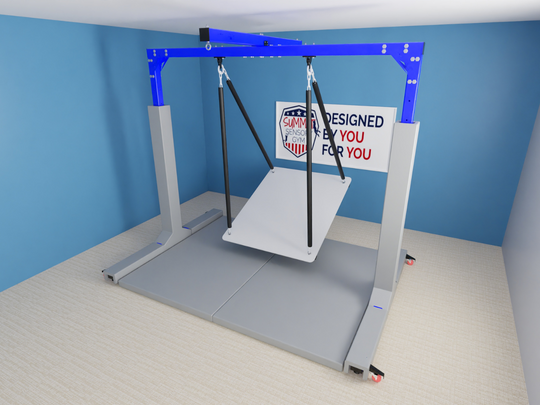 A free-standing mobile sensory gym featuring a sturdy blue and gray metal frame with an adjustable swing system. The structure includes an XL platform swing suspended by durable straps, designed for therapy and sensory activities. The unit is mounted on a carpeted floor and has wheels for easy mobility. A sign on the back reads "Designed by You, for You," with the Summit Sensory Gym logo prominently displayed.