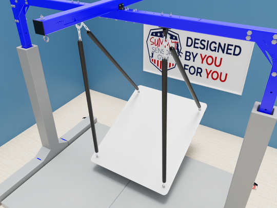 A free-standing mobile sensory gym featuring a sturdy blue and gray metal frame with an adjustable swing system. The structure includes an XL platform swing suspended by durable straps, designed for therapy and sensory activities. The unit is mounted on a carpeted floor and has wheels for easy mobility. A sign on the back reads "Designed by You, for You," with the Summit Sensory Gym logo prominently displayed.